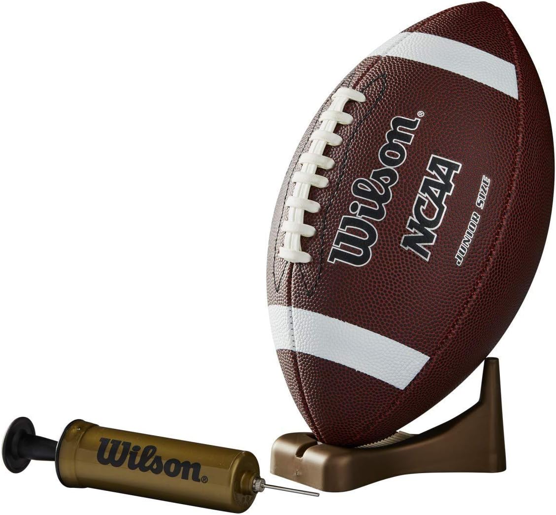 Youth player practicing with Wilson Junior Football on a grass field